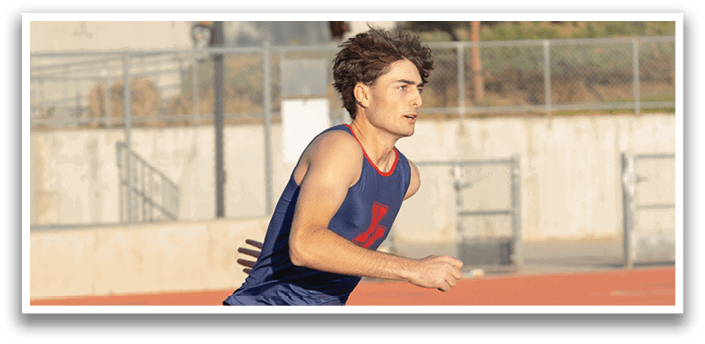 A man is running on a track, wearing a blue and red shirt. AI generated content
