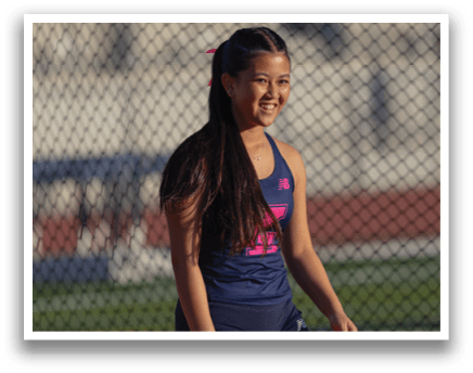 A girl in a blue and pink outfit is standing on a field. AI generated content