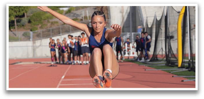 A woman is jumping in the air on a track, wearing a blue and red outfit. AI generated content