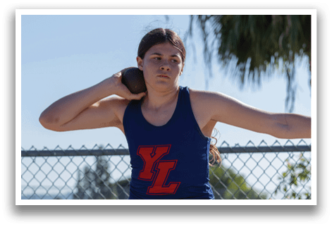 A woman wearing a blue and red shirt is throwing a frisbee. AI generated content