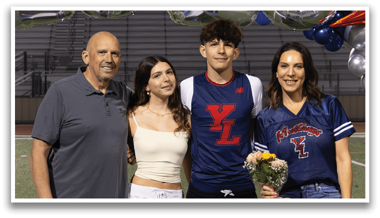 A group of people are standing on a football field in front of a banner that says 2026. AI generated content
