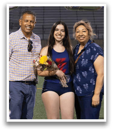 Three people are standing on a football field, posing for a picture. One of the women is holding a trophy. AI generated content