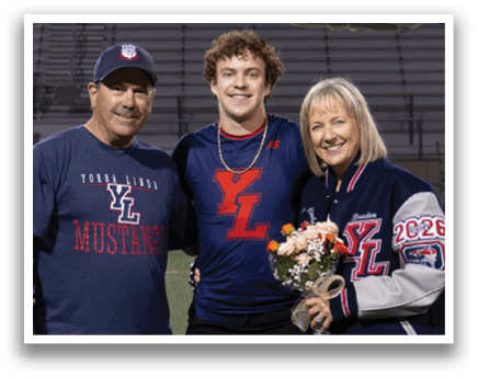 A man and woman pose for a photo on a football field. AI generated content