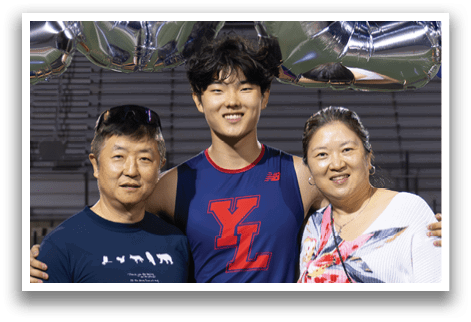 A man and woman stand on a field with a banner that reads “2026" behind them. AI generated content