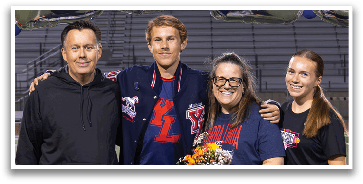 A group of people posing for a photo on a football field. AI generated content