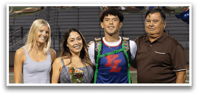 A group of people pose for a photo in front of a banner that reads 2026. AI generated content