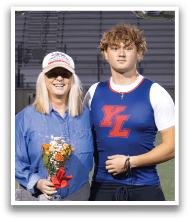 A man and woman stand on a football field in front of a banner that reads 2026. AI generated content