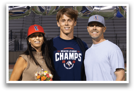 A man and woman pose for a picture in front of a banner that reads “2026." AI generated content