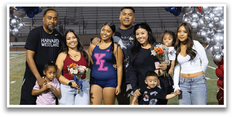 A group of people, including a man and a woman, pose for a photo in front of a banner that reads “2016." AI generated content