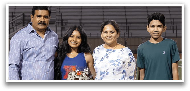A family poses for a photo in front of a banner that reads 2026. AI generated content