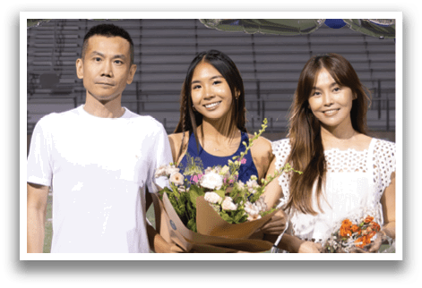 A man and two women are standing in front of a banner that reads 2026. AI generated content