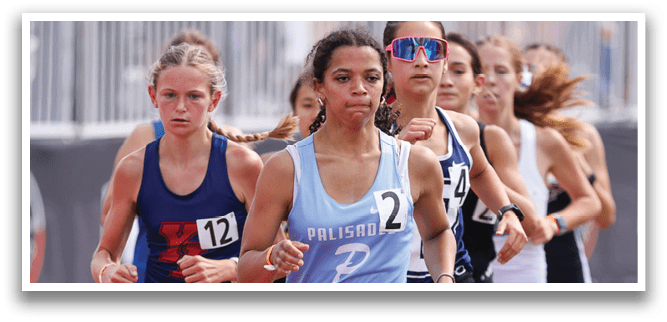 A group of girls running on a track. Description generated by AI