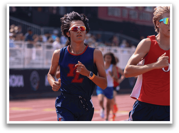Two runners on a track. Description generated by AI