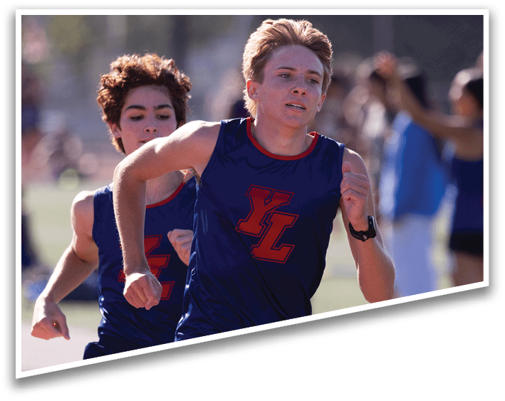 Two boys running on a field. Description generated by AI