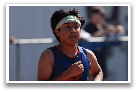 A woman running on a track. Description generated by AI