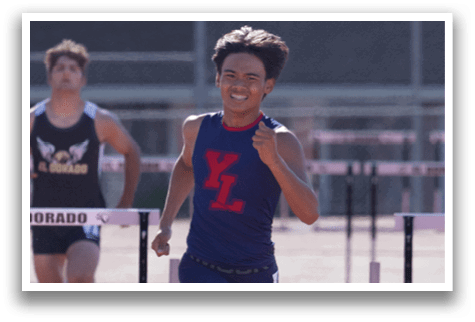 A boy running on a track. Description generated by AI