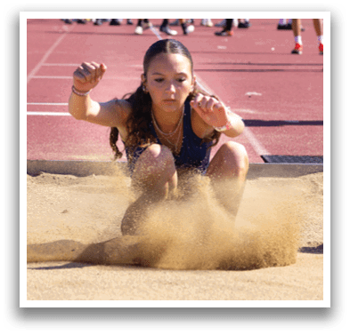 A woman is sliding in the dirt. Description generated by AI