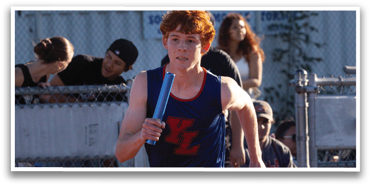 Two boys running on a track. Description generated by AI