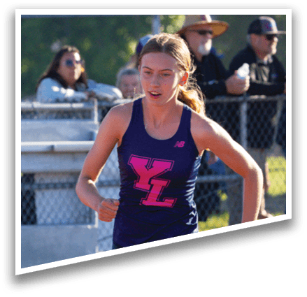 A woman running on a track. Description generated by AI