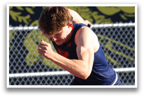 A man running on a track. Description generated by AI