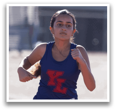 Three girls running on a track. Description generated by AI