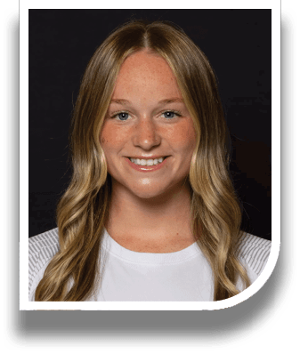 A woman with blonde hair and freckles smiles for the camera. AI generated content