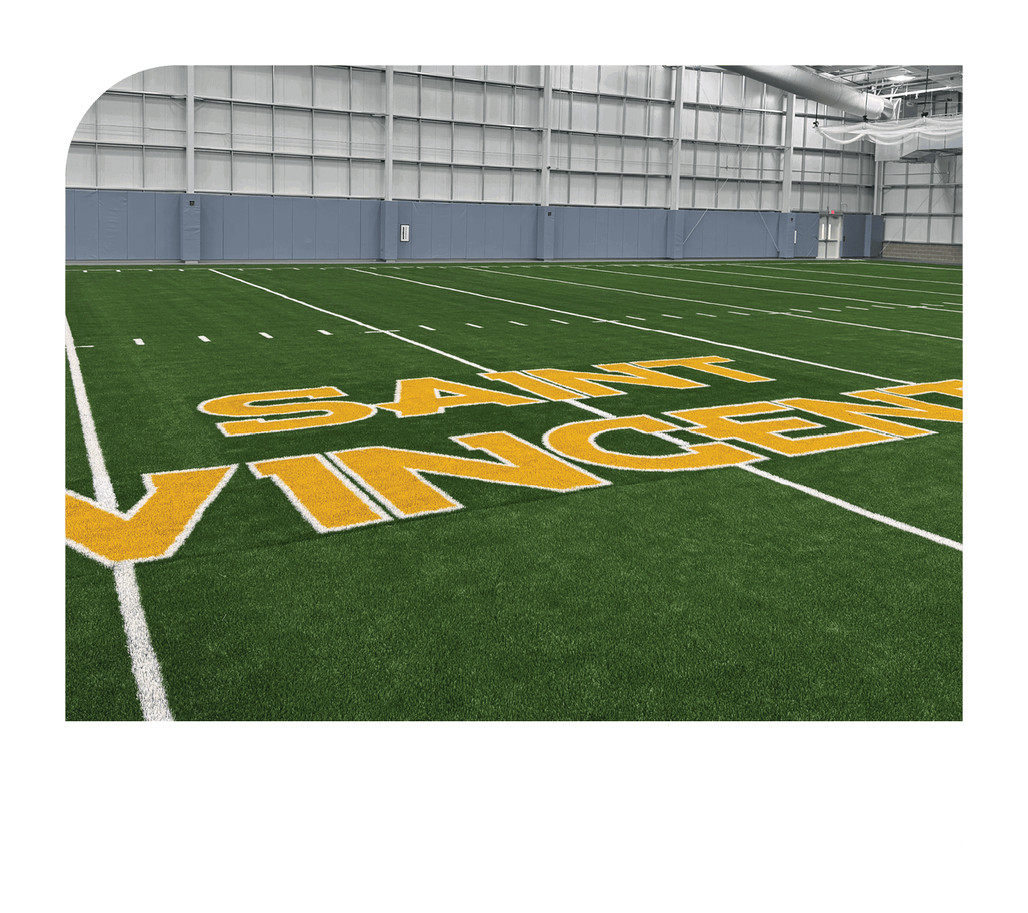 A football field with a yellow sign that says Saint Vincent. AI generated content