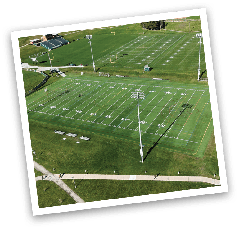 A large grassy field with a soccer field and a baseball field. AI generated content
