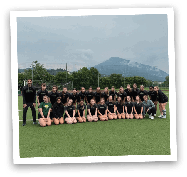A group of women pose for a picture on a field. AI generated content