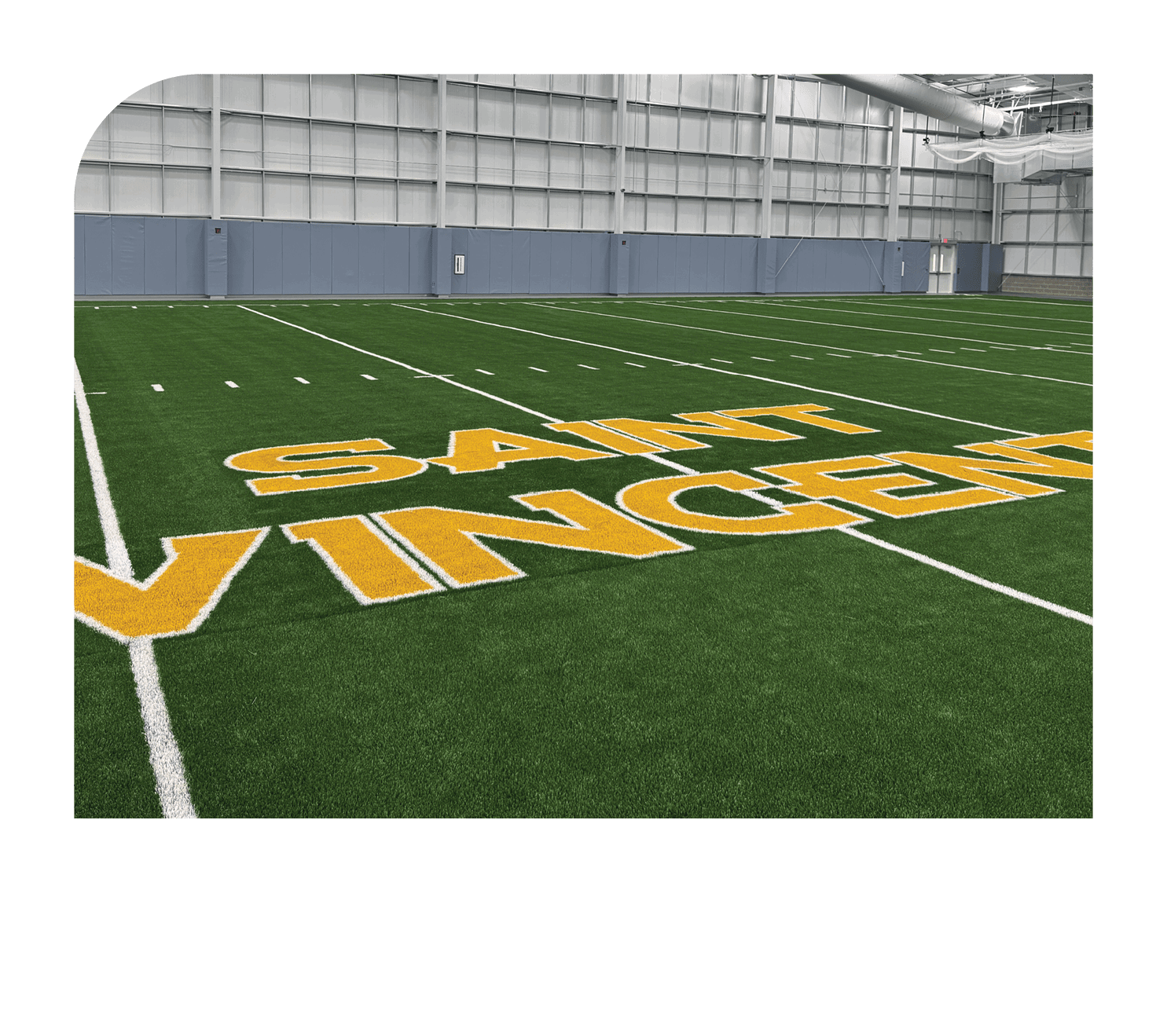 A football field with a yellow sign that says Saint Vincent. AI generated content