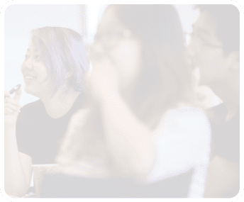A woman with purple hair is applying makeup while sitting next to another woman. AI generated content