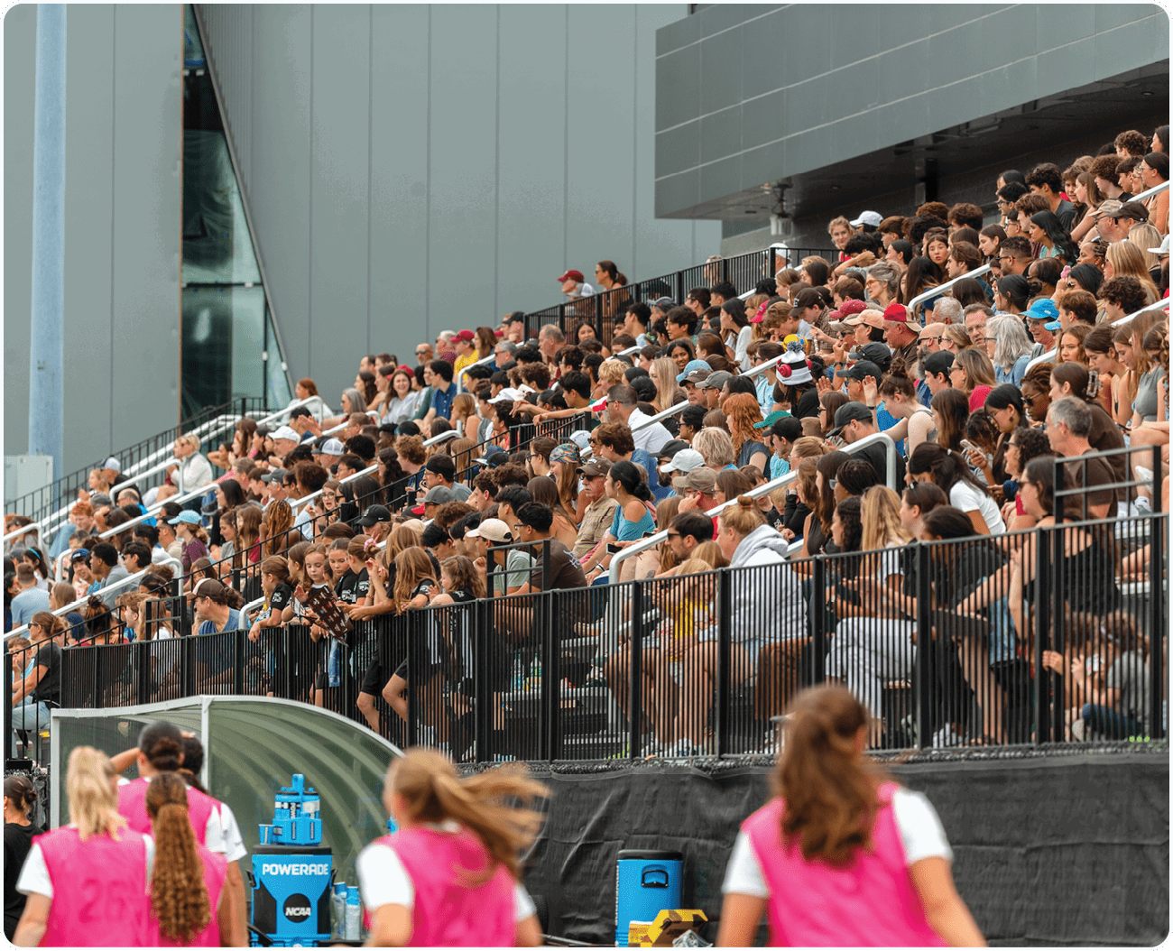 A large crowd of people are sitting in a stadium, watching an event. AI generated content