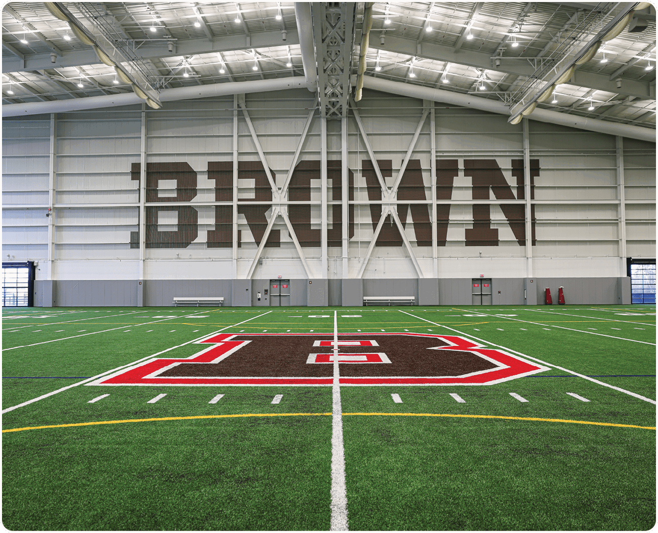 A football field with a large brown sign that says “Brown" on it. AI generated content