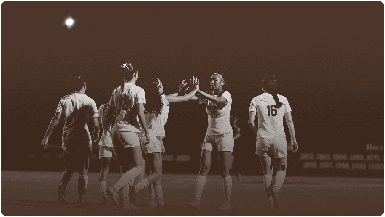 Four female soccer players are on the field, celebrating a goal. AI generated content