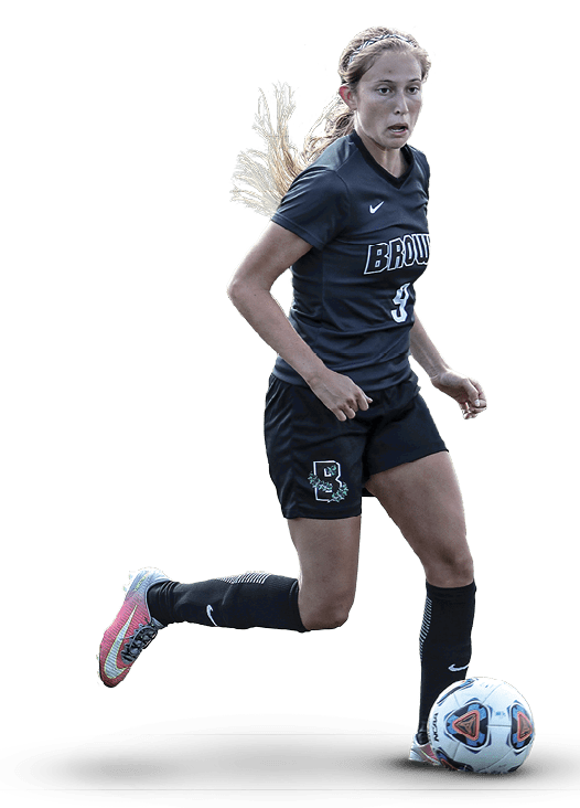 A female soccer player in a black and white uniform is running towards a soccer ball. AI generated content