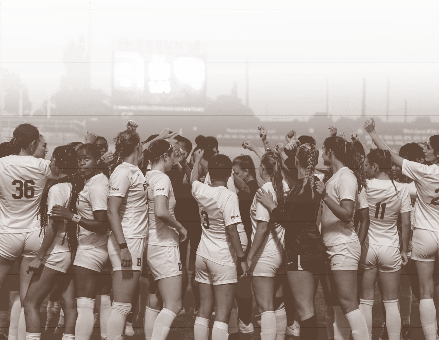A group of female athletes wearing white uniforms are huddled together on a field. AI generated content