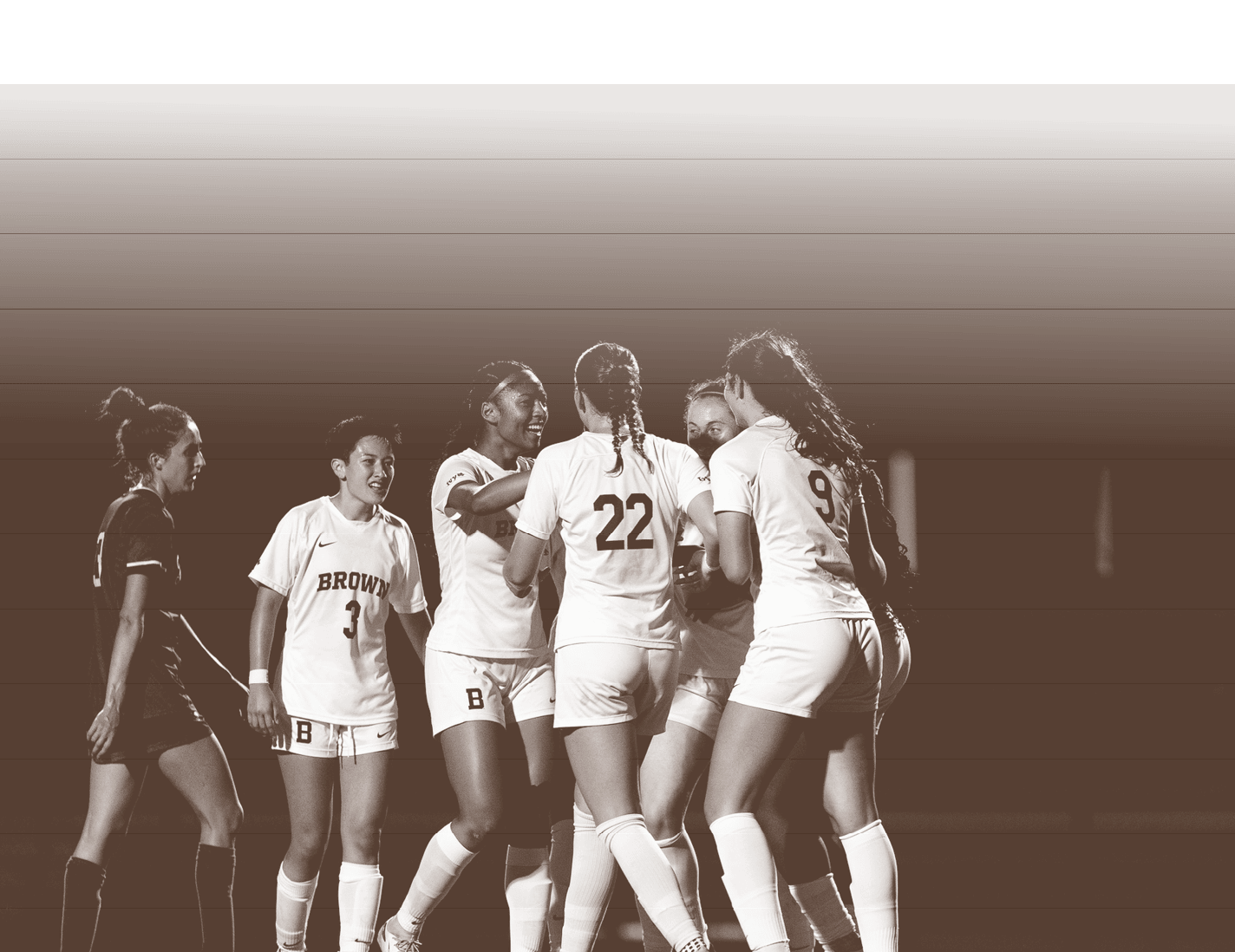 Four female soccer players huddle together on the field, celebrating a successful play. AI generated content