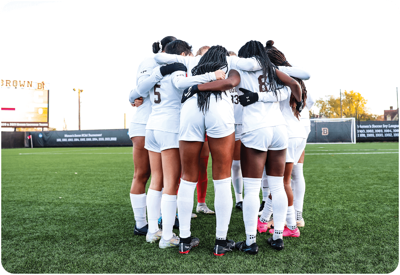 A group of female soccer players huddle together on the field. AI generated content