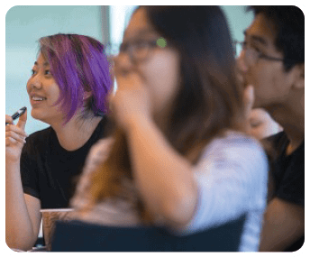 A woman with purple hair is applying makeup while sitting next to another woman. AI generated content