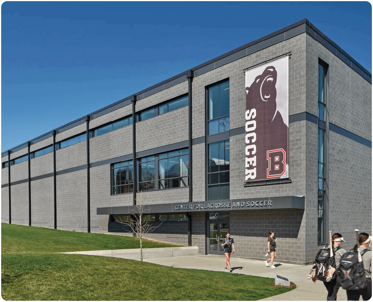 A group of people walking in front of a building with a soccer sign on it. AI generated content