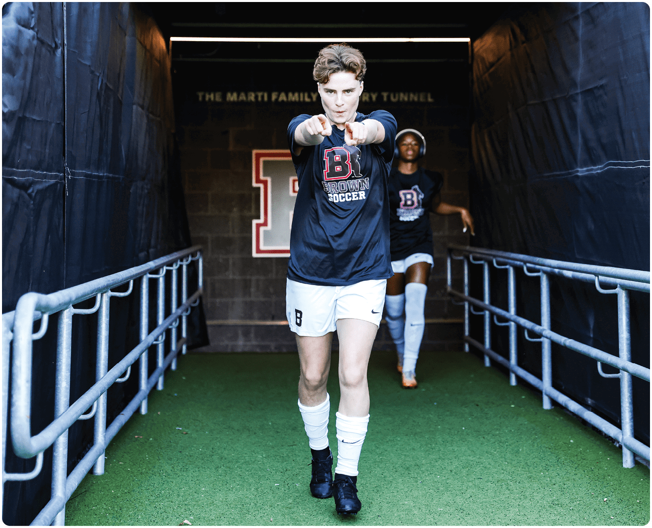 A man wearing a black shirt and white shorts walks down a tunnel. AI generated content