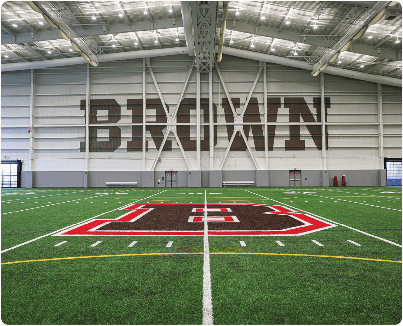 A football field with a large brown sign that says “Brown" on it. AI generated content