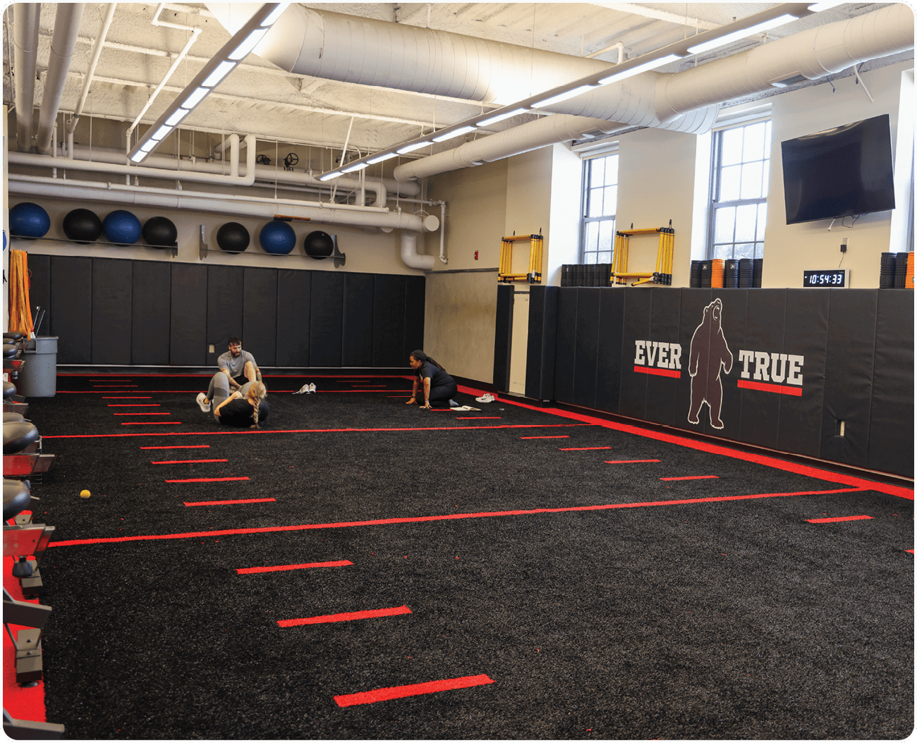 A man is kneeling on a mat in a gym, possibly doing a workout. AI generated content