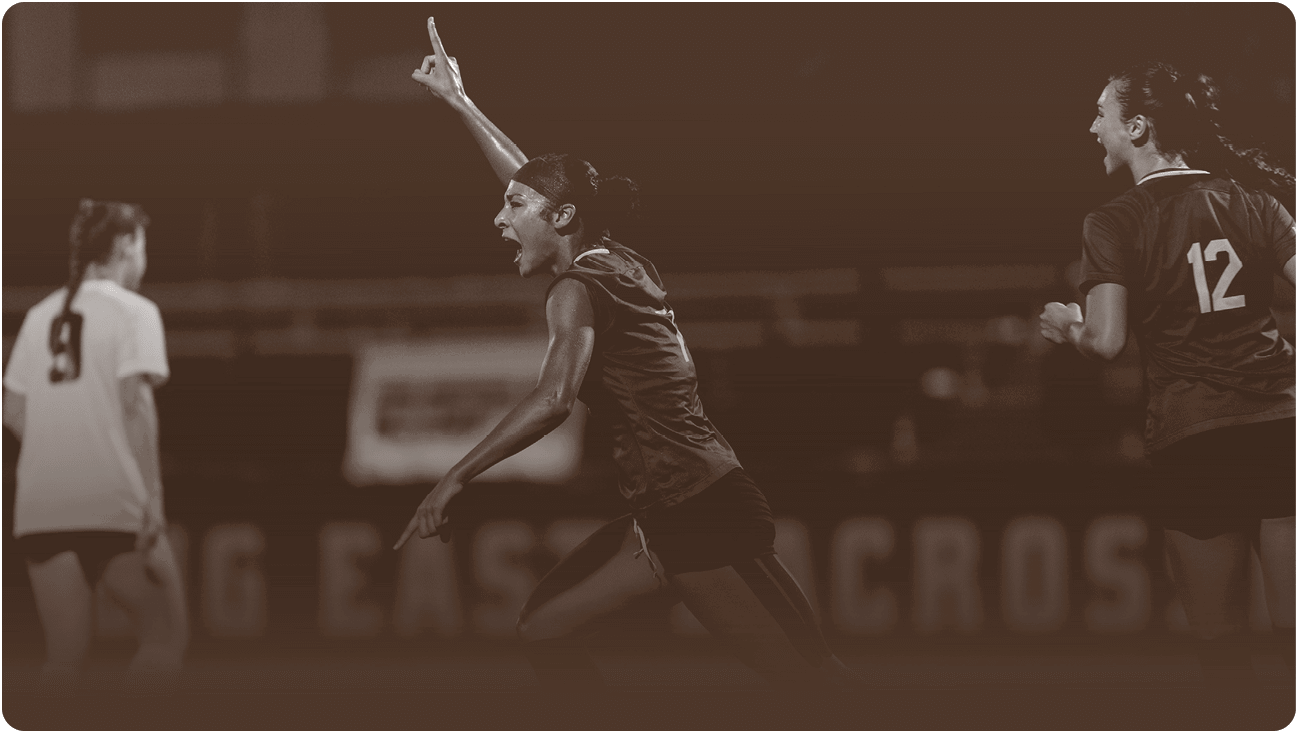 Two girls are playing soccer, one is pointing upwards while the other is laughing. AI generated content