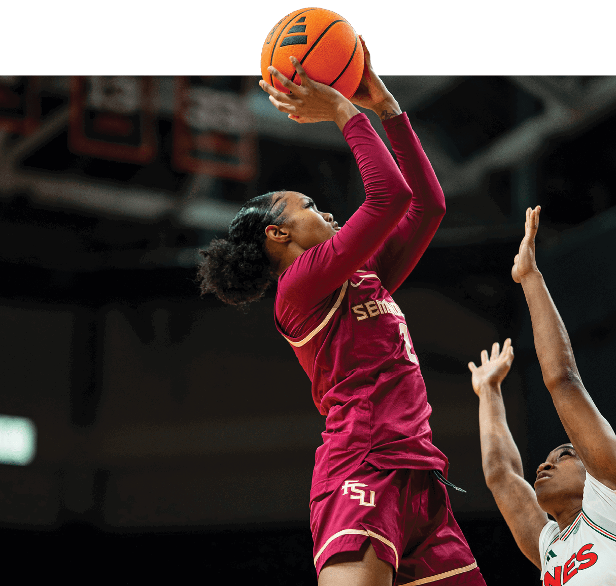 A female basketball player leaps in the air to block a shot. AI generated content