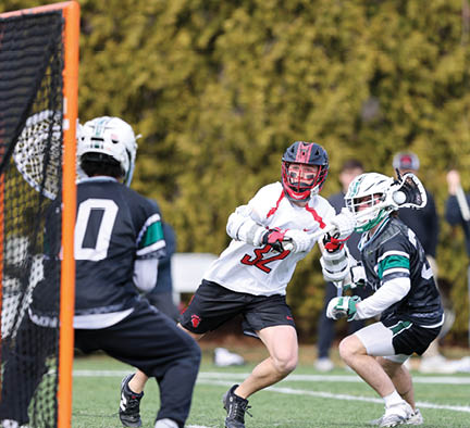 A man in a white shirt is playing lacrosse. Description generated by AI