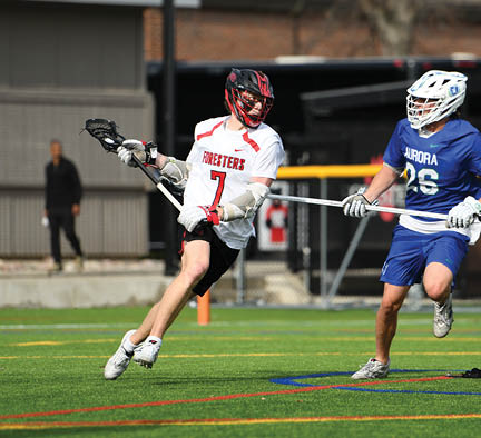 A man in a white jersey is running with a black and red stick. Description generated by AI