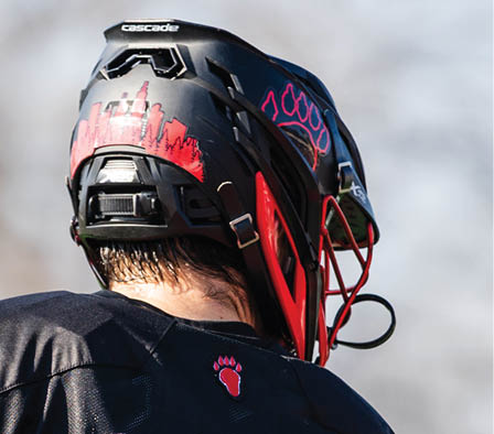 A man wearing a black and red jersey with the number 34 on it. Description generated by AI