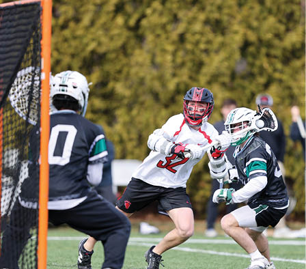 A man in a white shirt is playing lacrosse. Description generated by AI