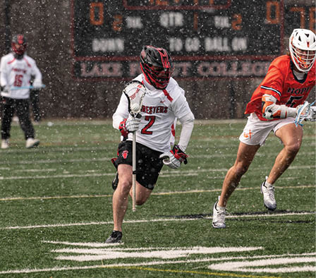 A man in a white and red uniform is running on a field. Description generated by AI